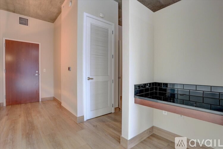 A room with a wooden floor and a white door.