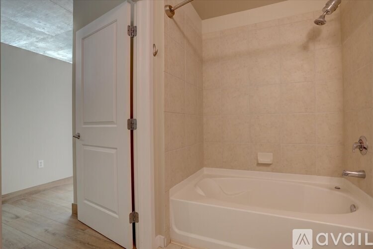 A bathroom with a tub and a door.