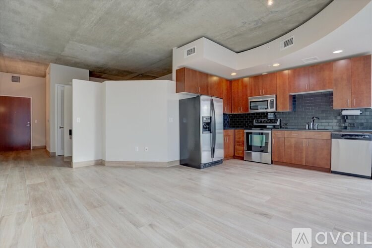 A kitchen with wooden cabinets and a white refrigerator.