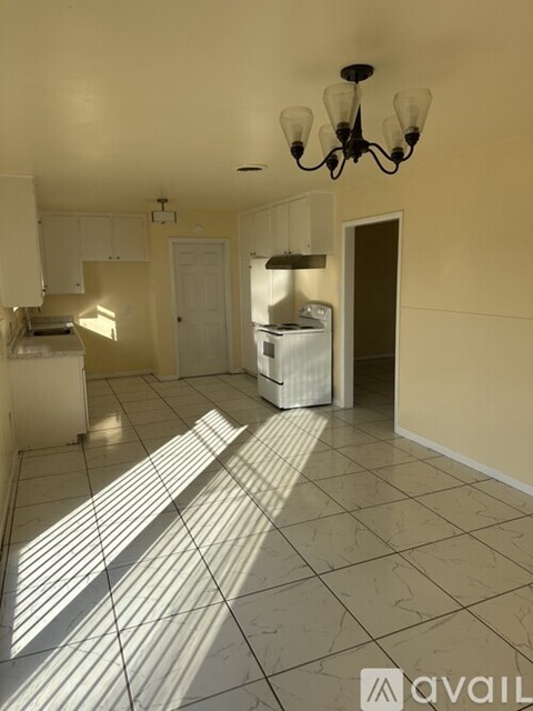 A kitchen with a refrigerator, a dishwasher, and a microwave.