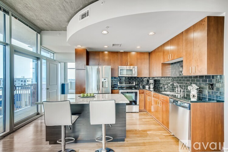 A modern kitchen with a dining table and chairs.