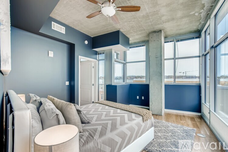 A living room with a grey sofa and a round table.