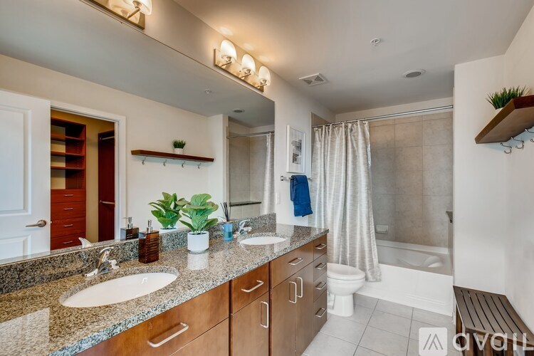 A bathroom with a sink, toilet, and shower.