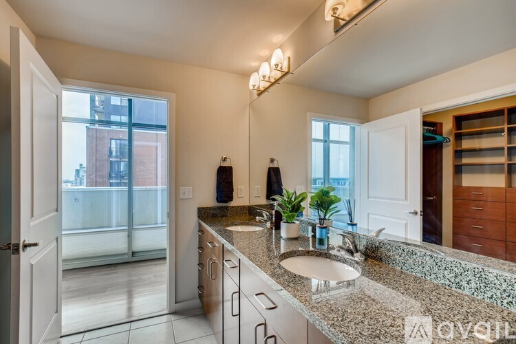 A modern kitchen with granite countertops and stainless steel appliances.