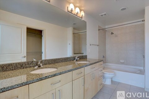 A bathroom with a sink, toilet, and bathtub.
