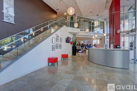 A reception area with a glass staircase and a reception desk.