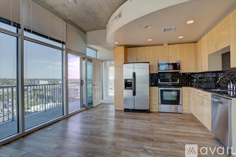 A kitchen with wooden floors and stainless steel appliances.