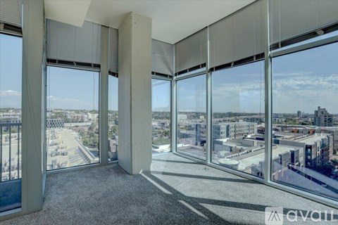 A room with large windows overlooking a cityscape.