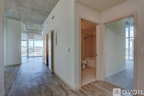 A spacious room with a bathroom visible through the open door.