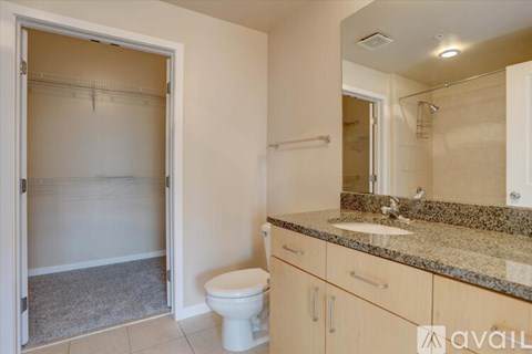 A bathroom with a toilet, sink, and shower.