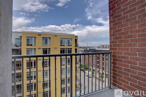 A view from a balcony overlooking a yellow building.