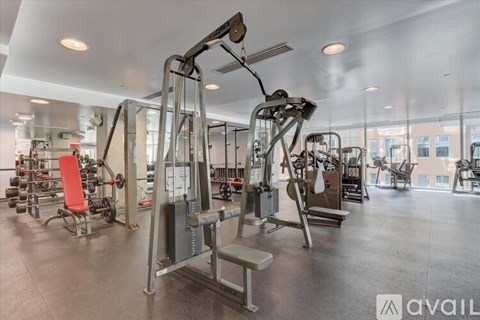 A gym with a variety of equipment including a leg press machine.