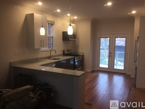 A kitchen with a sink, stove, and a window.
