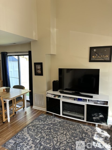 A living room with a television and a table.
