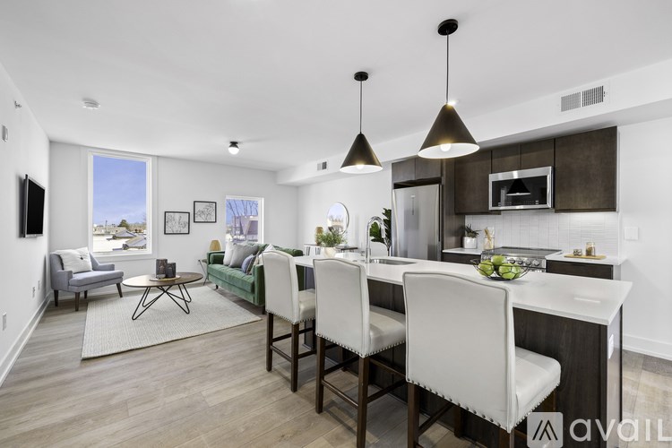 A modern kitchen with a dining table and chairs.