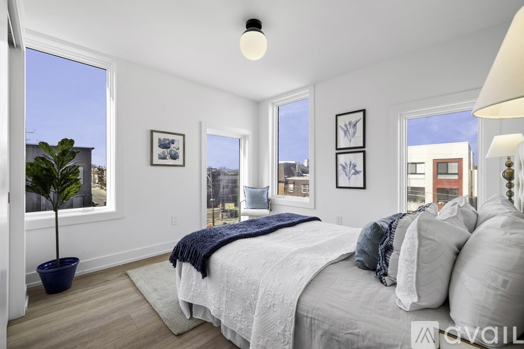 A bedroom with a large bed and a view of the city.