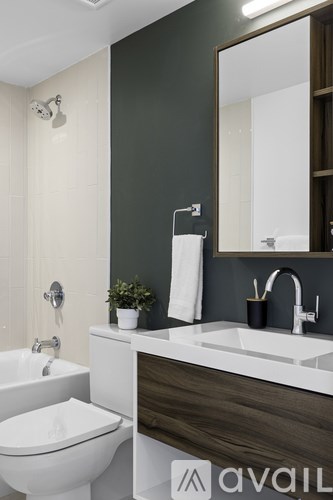 A modern bathroom with a white toilet and a white sink.