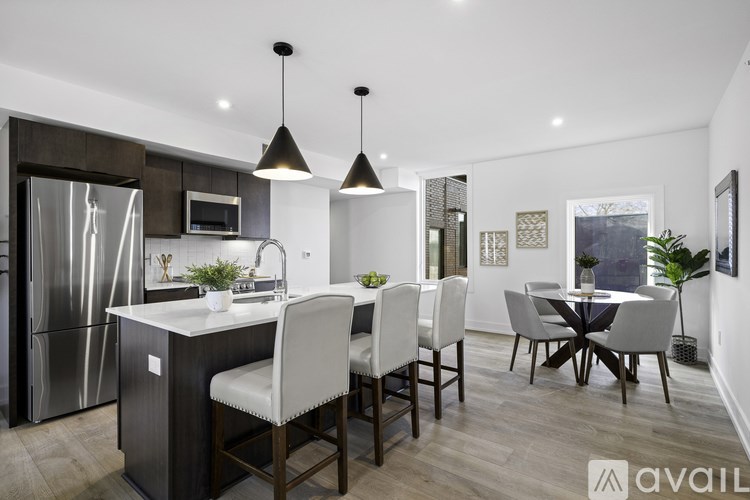 A modern kitchen with a dining table set for four.