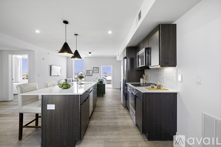 A modern kitchen with dark wood cabinets and a center island.