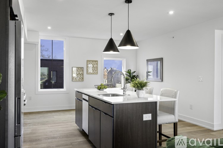 A modern kitchen with a white countertop and a large island.
