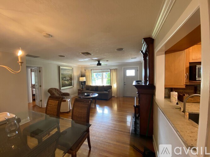 A living room with a glass table and chairs.