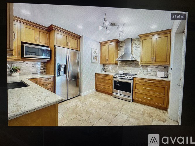 A kitchen with wooden cabinets and a granite countertop.