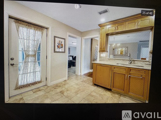 A kitchen with wooden cabinets and a tiled floor.