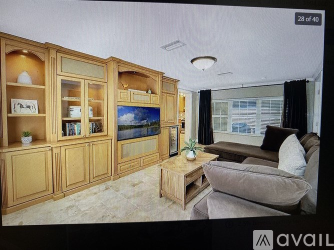 A living room with a couch, a coffee table, and a television.