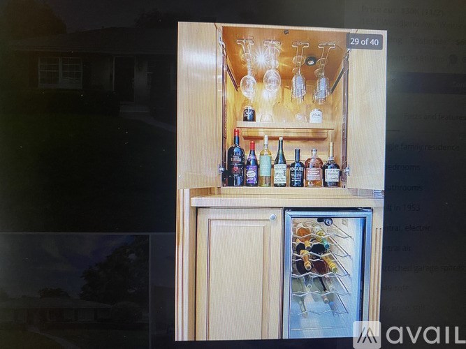 A fridge with a glass door is filled with bottles.