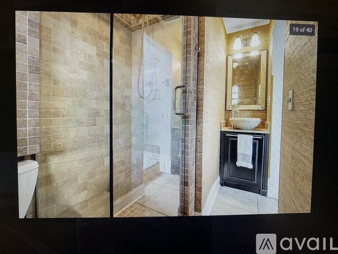 A bathroom with a walk-in shower and a sink.