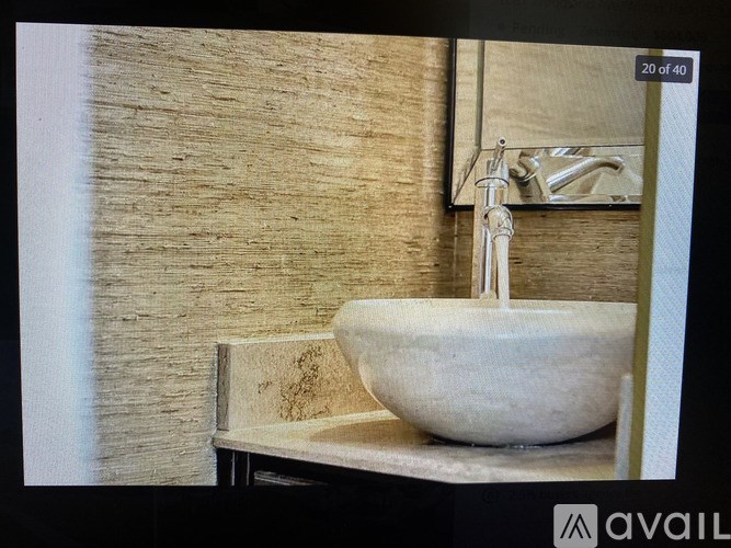 A white sink is on a counter with a faucet.