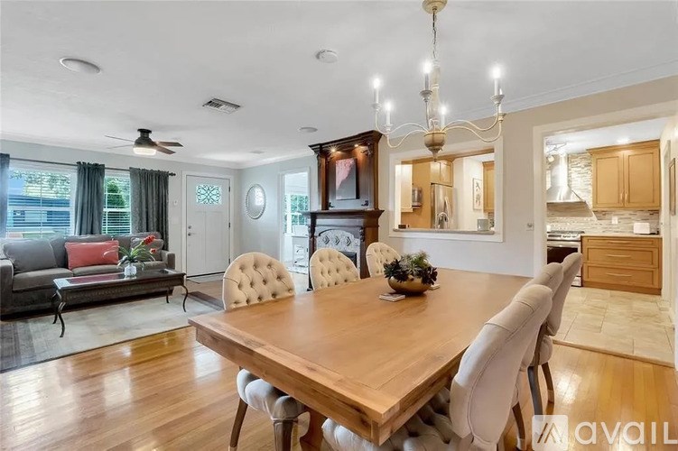 A dining room with a wooden table and chairs.