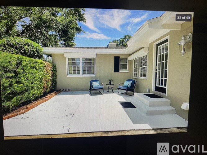 A house with a patio and a blue chair.