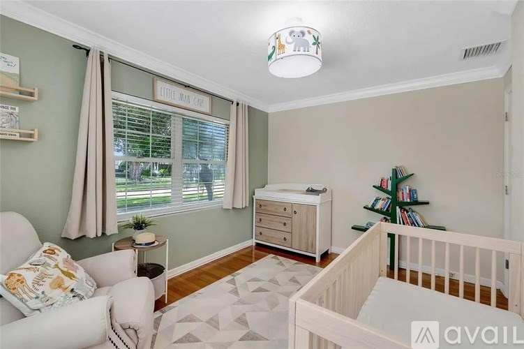 A baby nursery with a crib, a changing table, and a dresser.