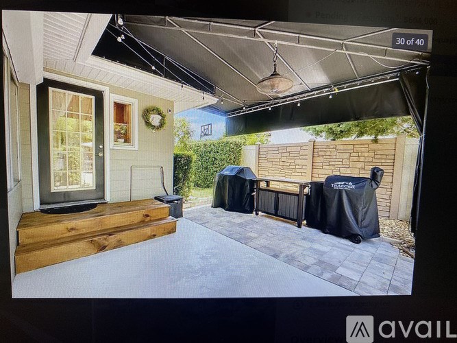 A patio area with a black tarp covering a table and chairs.