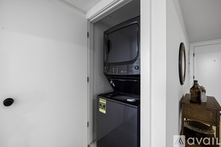 A black microwave oven is built into a cabinet.