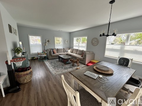 A living room with a wooden table and chairs.