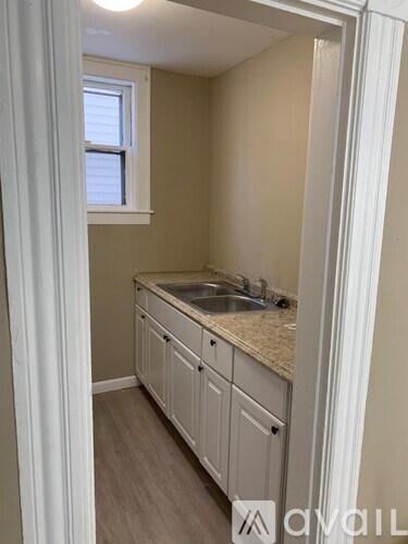 A small kitchen with a sink and cabinets.