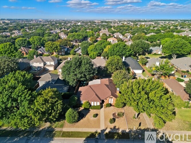 A bird's eye view of a residential neighborhood with houses and trees.