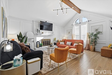 A living room with a black chair and a white couch.