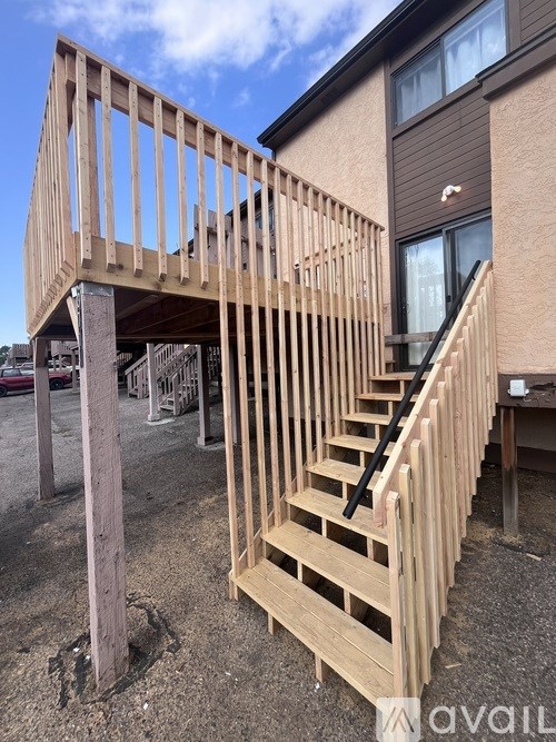 A wooden staircase is being constructed in a backyard.