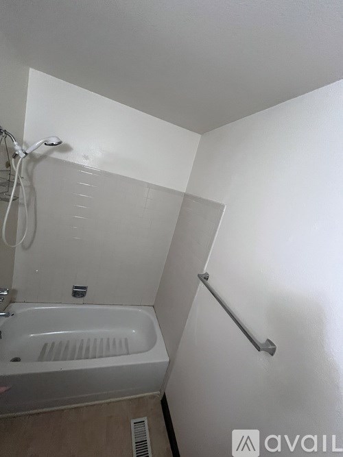 A white bathroom with a tub and a shower.