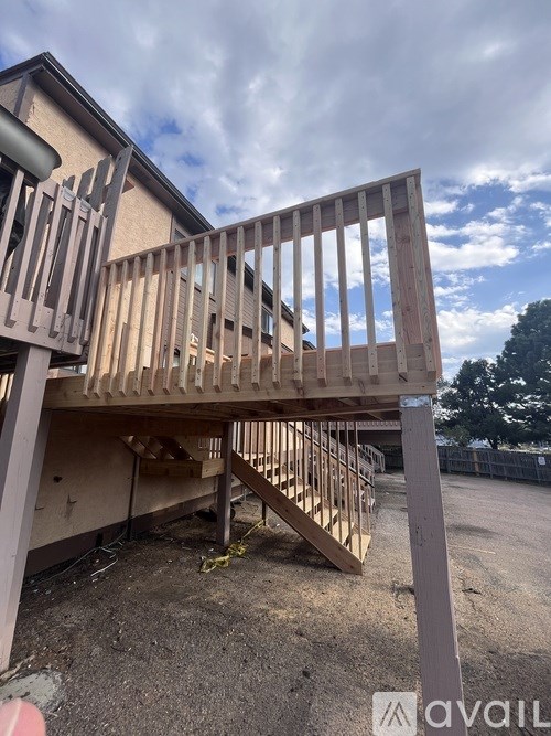 A wooden deck structure is under construction in a sunny outdoor setting.