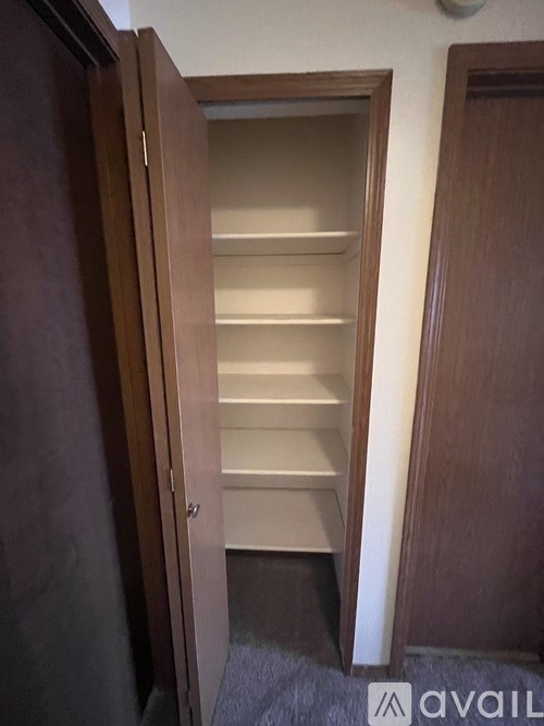 A wooden closet with shelves and a sign that says "available".