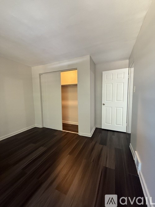 A room with wooden floors and white walls.