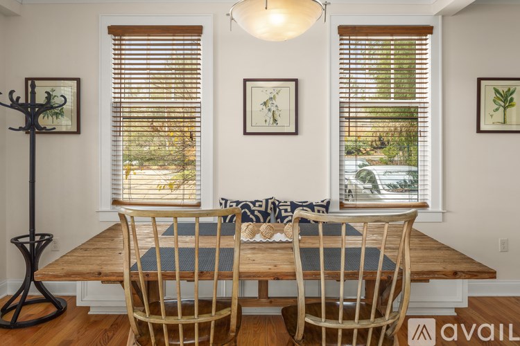 A dining room with a wooden table and chairs.