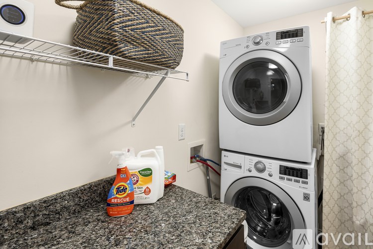 A laundry room with a washer and dryer stacked on top of each other.