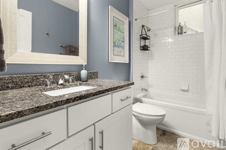 A bathroom with a sink, toilet, and bathtub.