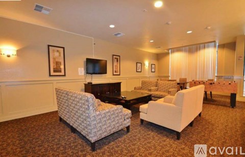 A living room with a patterned chair and a white chair.