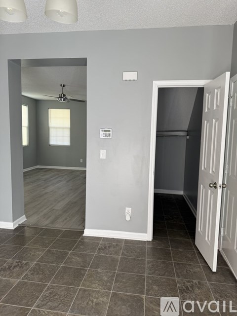 A kitchen with wooden cabinets and a stainless steel refrigerator.